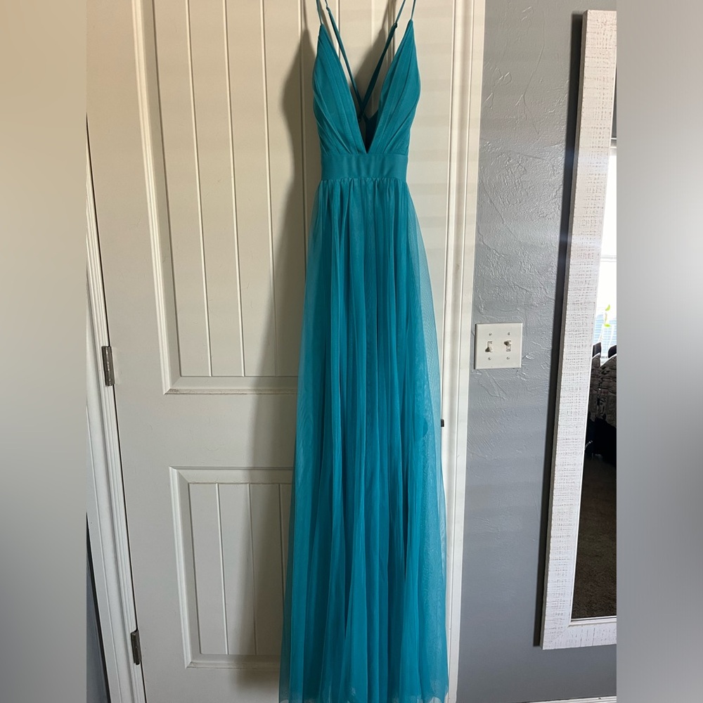 Prom dress, teal color, says size 3 but fits like a 4